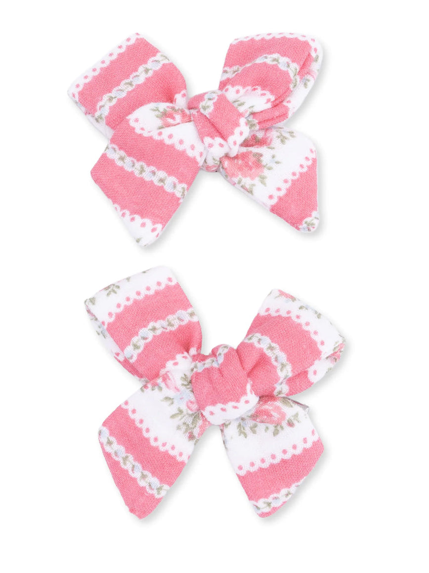Two pink and white hair bows with floral patterns and stripes, ideal for adding a cute touch to hairstyles.