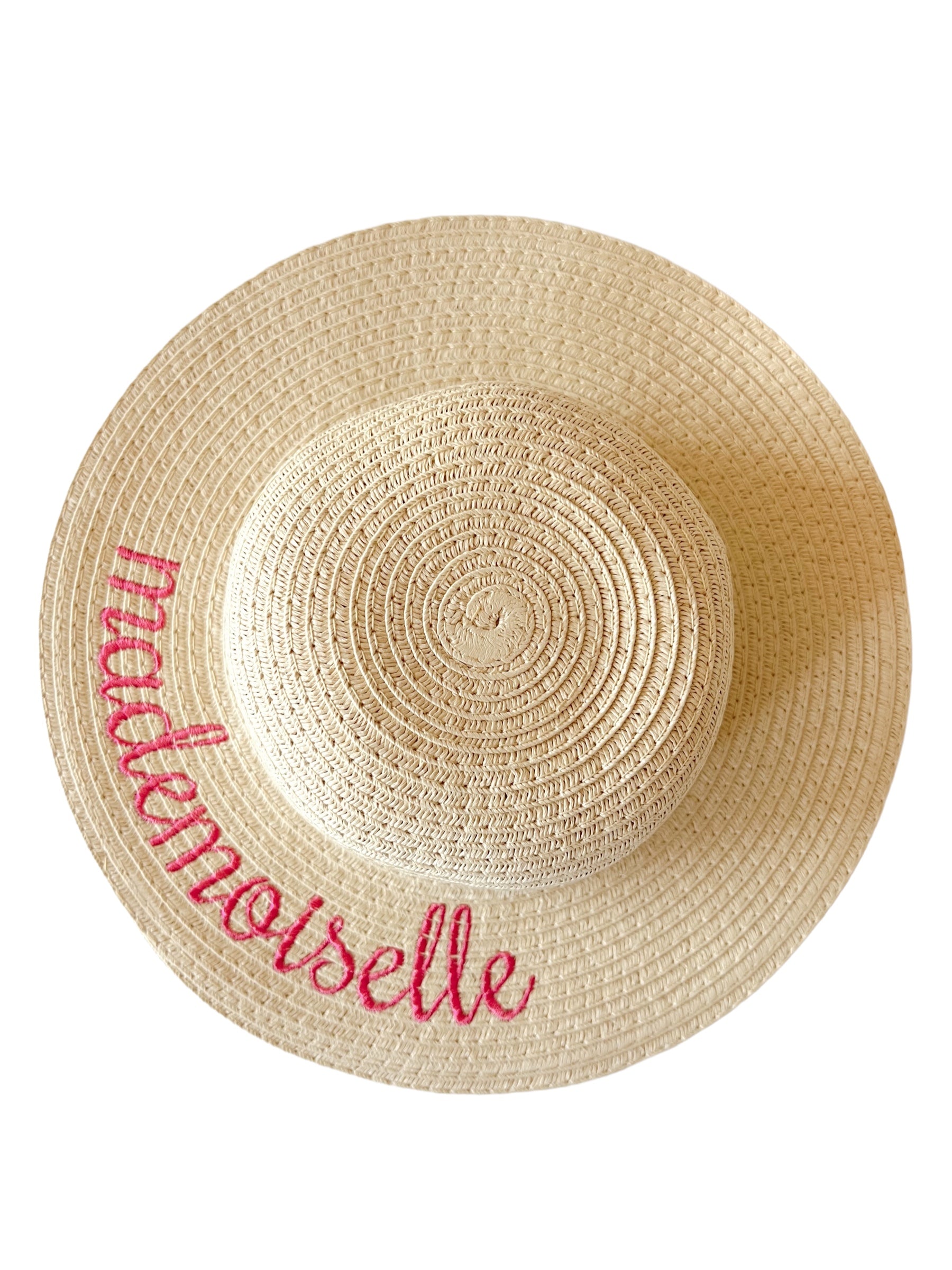 Wide-brimmed straw hat with the word "mademoiselle" embroidered in pink along the edge.