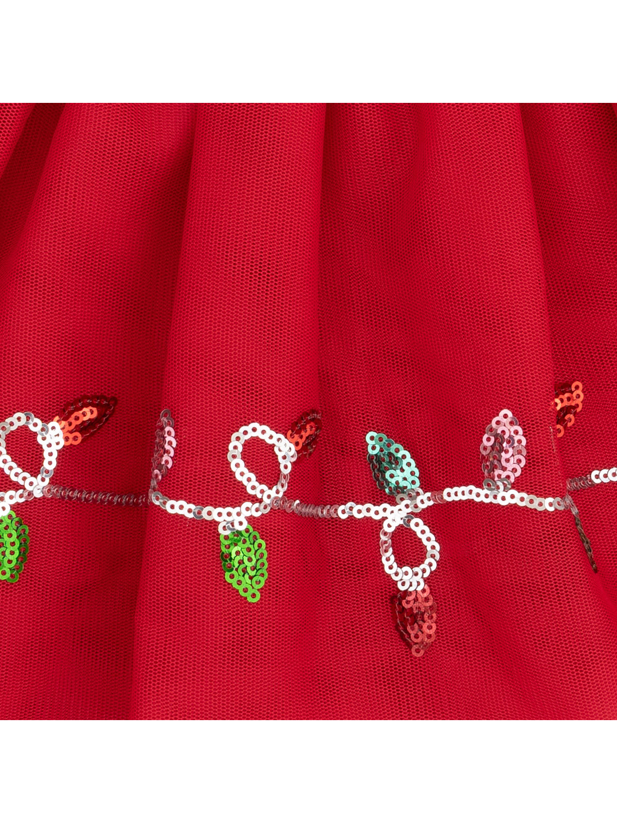 Red fabric with sequined leaf design in green, pink, and gold along the hem, creating a decorative pattern.