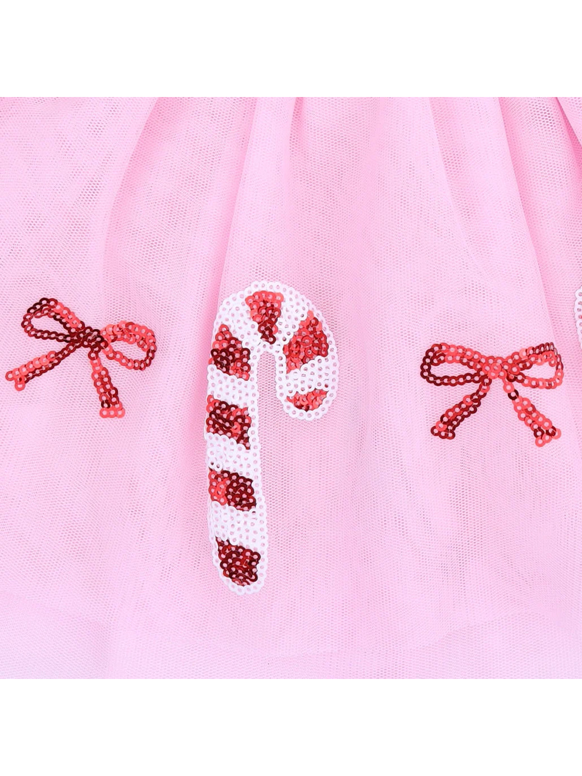 Pink tulle fabric featuring sequin candy canes and bows for a festive design.