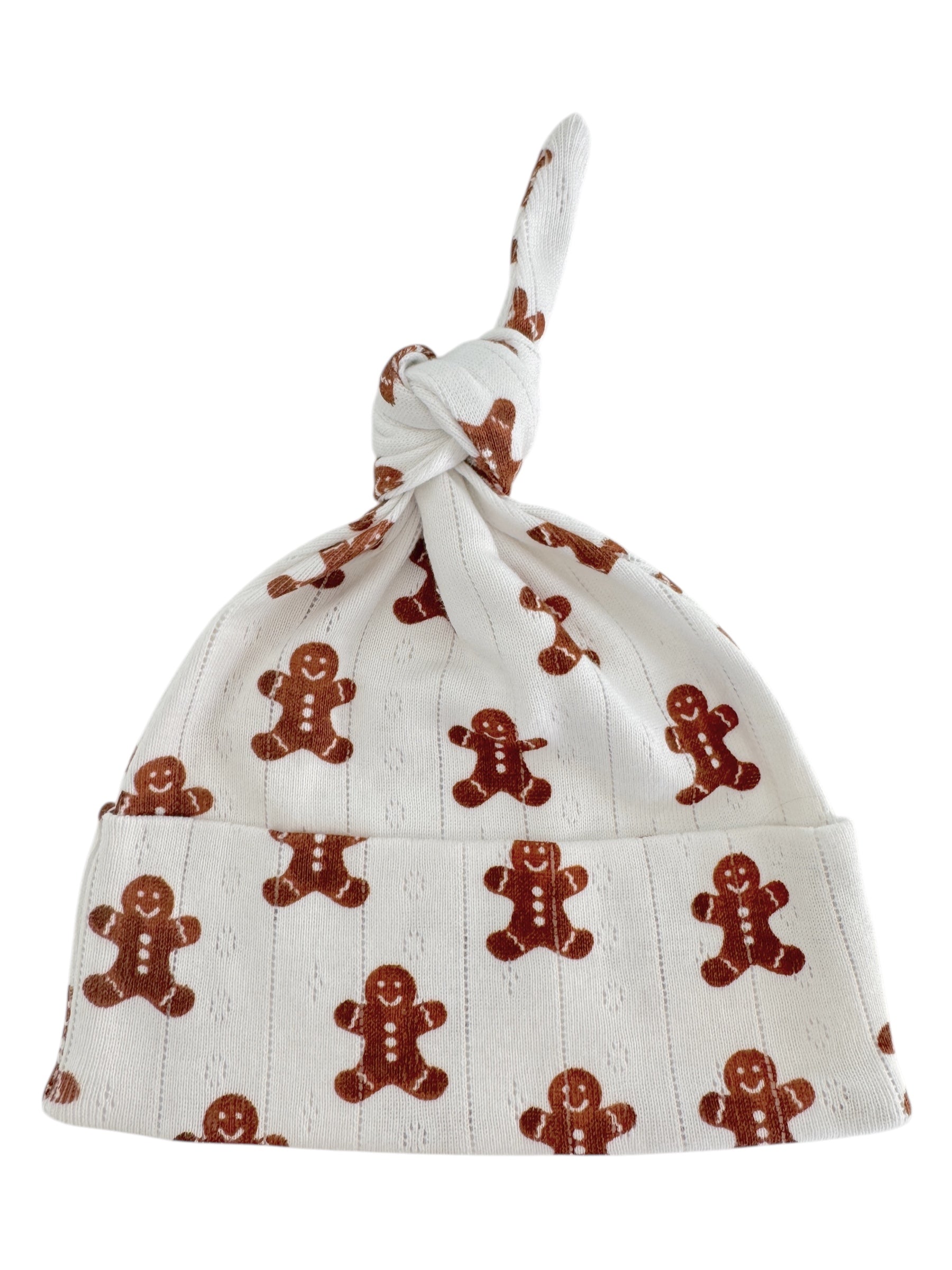 Baby hat with a knot design, featuring gingerbread man patterns on a white background.
