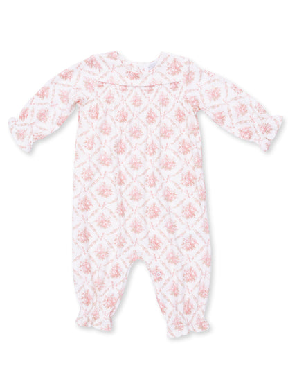 White long-sleeve baby romper with pink floral pattern and snap closures at the bottom.