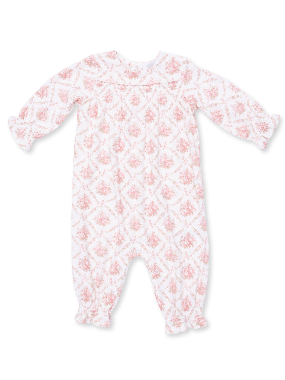 White long-sleeve baby romper with pink floral pattern and snap closures at the bottom.