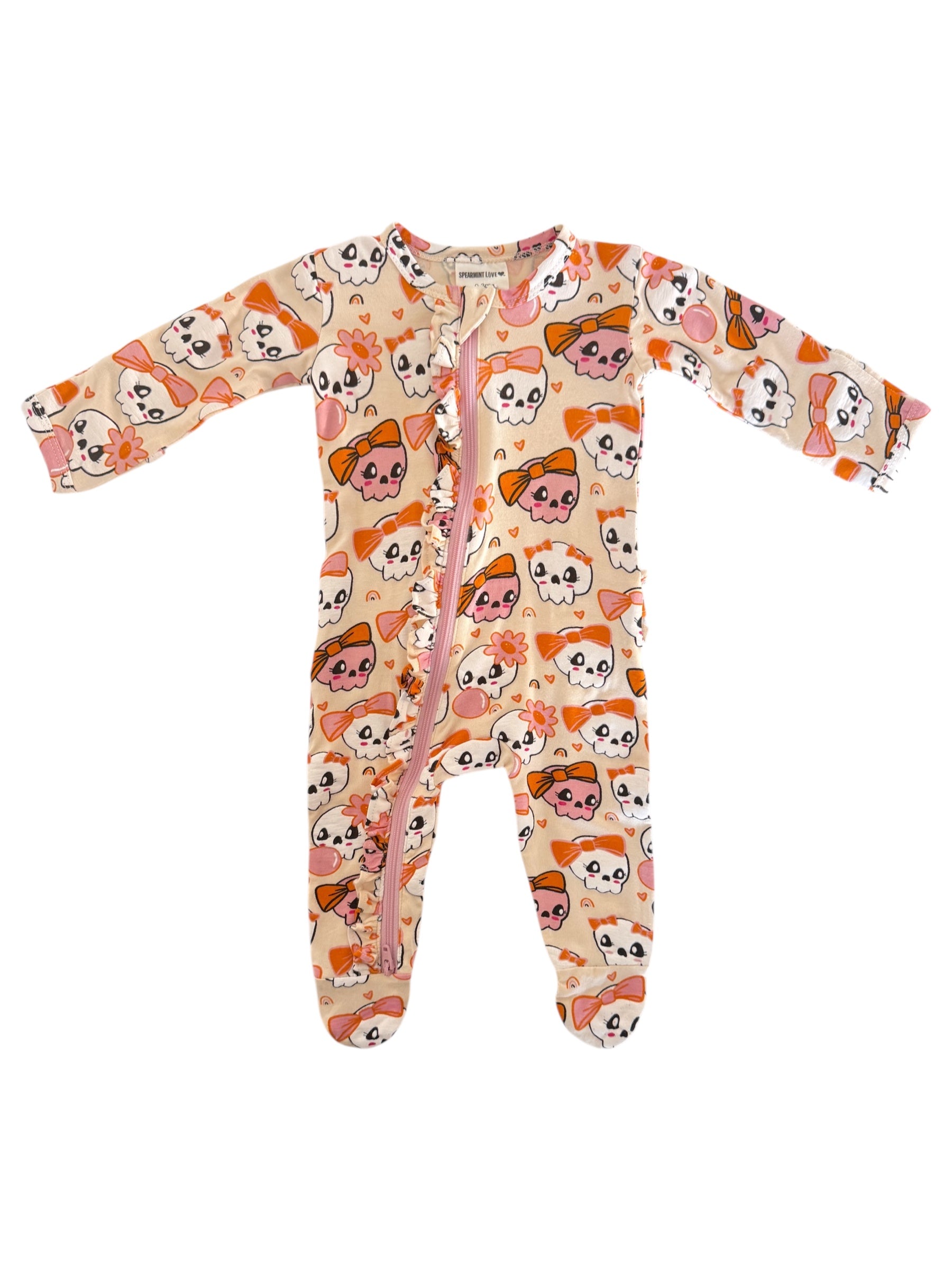Infant onesie with a playful skull and bow pattern in pink and orange colors, featuring a full front zipper.