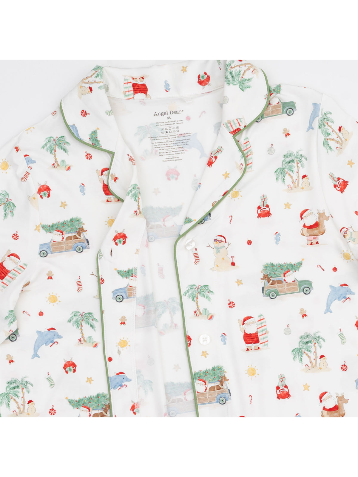 Festive pajama top featuring playful holiday patterns, including Santa, palm trees, and fun characters. Perfect for celebrations.