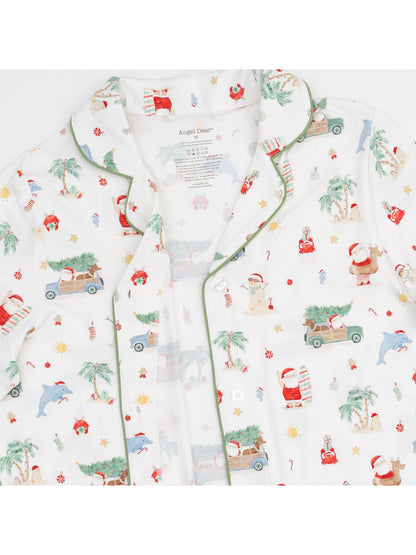Festive pajama top featuring playful holiday patterns, including Santa, palm trees, and fun characters. Perfect for celebrations.