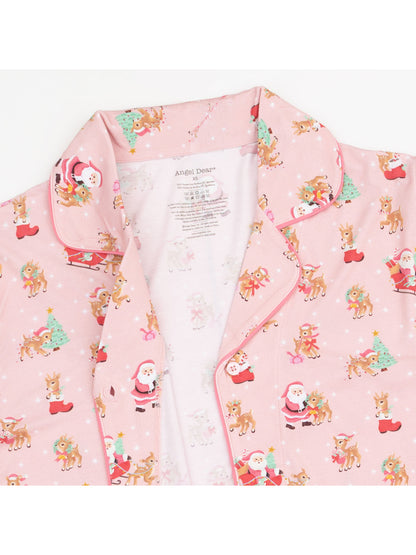 Pink pajama set featuring Santa, reindeer, and Christmas trees in a cheerful, festive print.