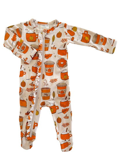 Child's onesie featuring autumn-themed patterns of pumpkins, coffee cups, and fall leaves in warm colors.
