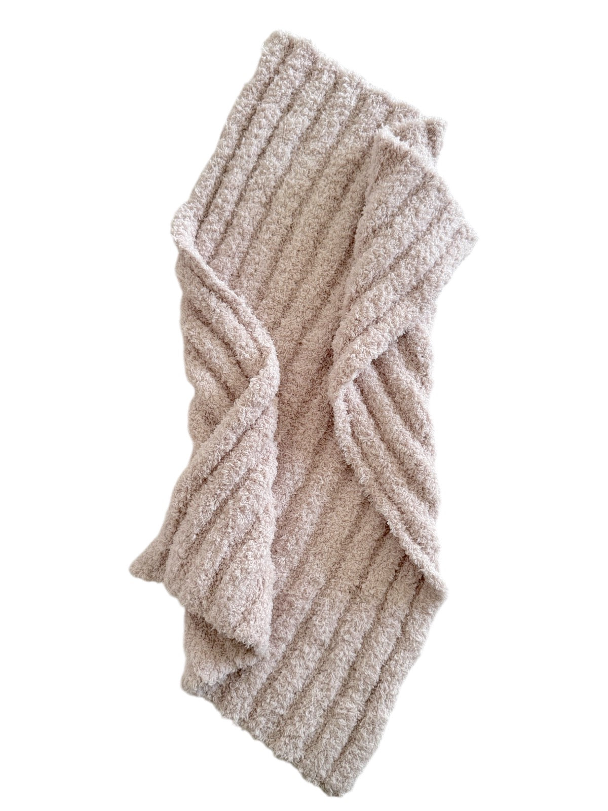 Cozy, textured beige blanket folded stylishly with ribbed pattern, perfect for warmth and comfort.