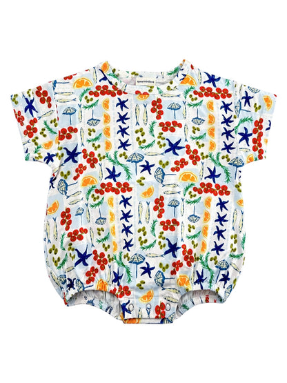 Colorful baby romper featuring fruit, starfish, and beach-themed patterns on a white background.