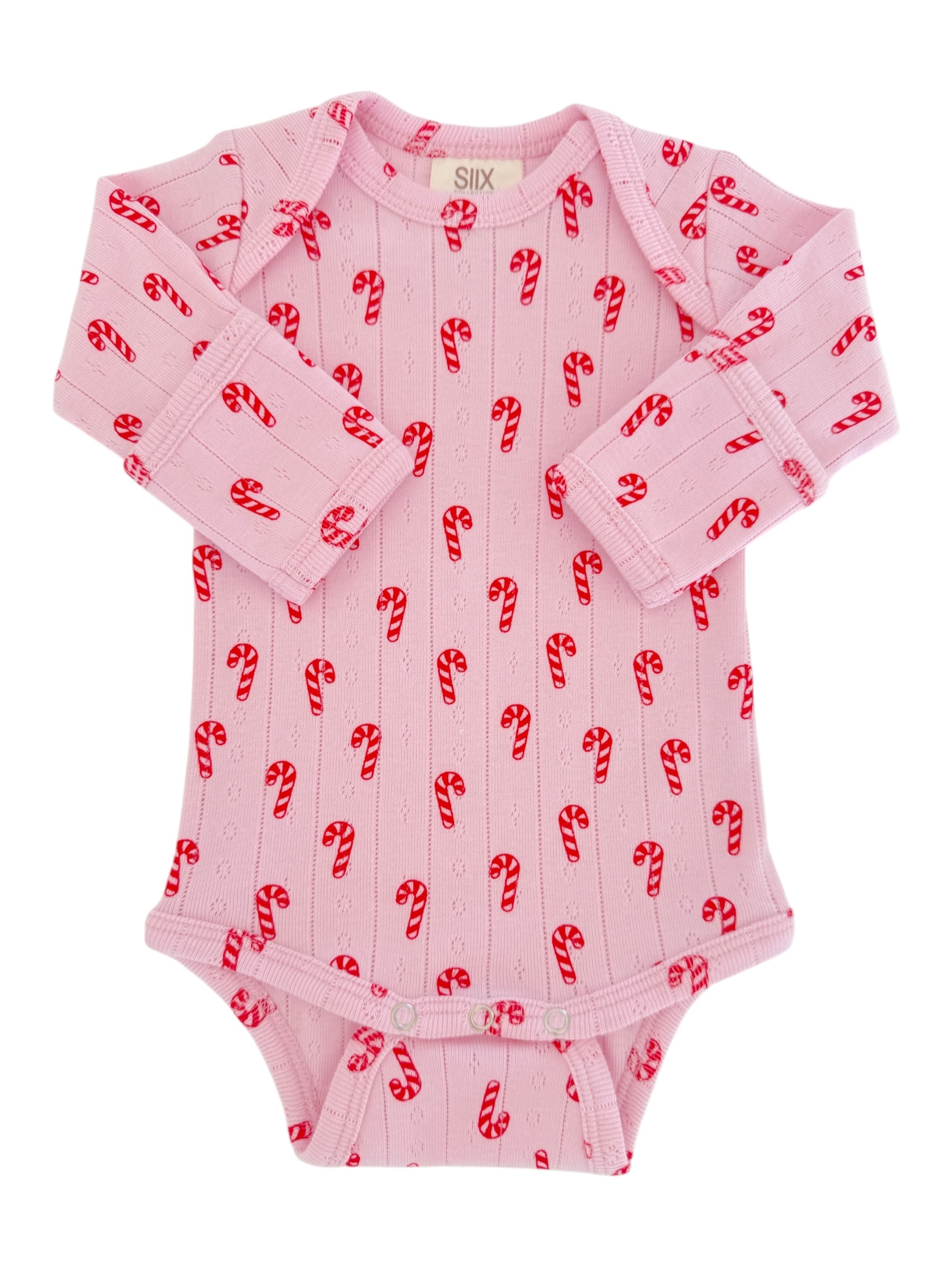 Pink baby onesie with red candy cane pattern, featuring long sleeves and snap closures at the bottom.