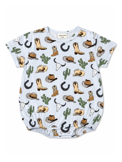 Light blue baby romper with cowboy boots, hats, cacti, and cattle motifs throughout the fabric.