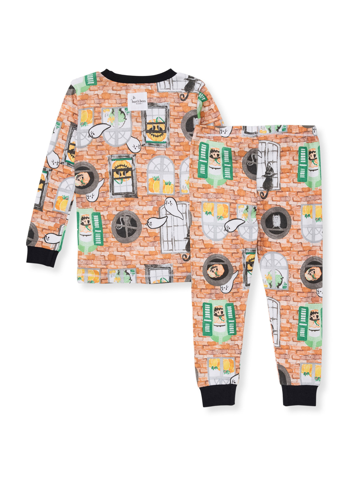 Child's pajamas featuring colorful, playful ghost and cat patterns on a brick background.