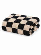 Black and beige checkered towel folded on a white background.