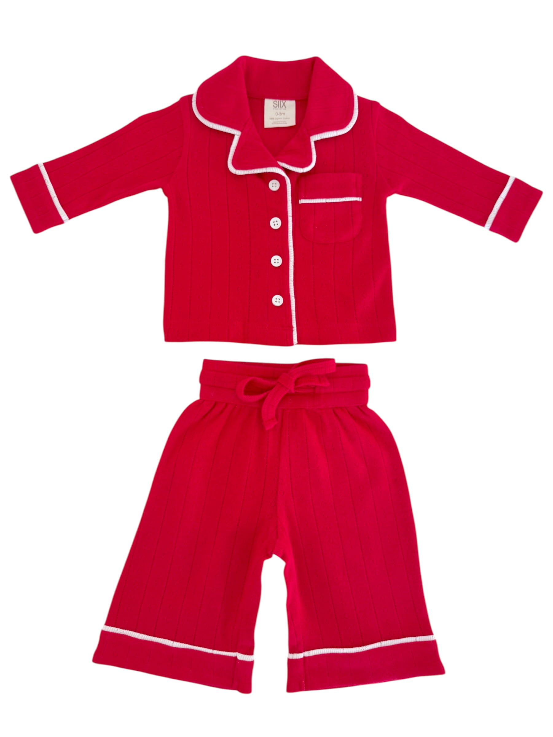 Red kids’ pajamas set with a collared button-up top and matching shorts, featuring white trim and vertical stripes.