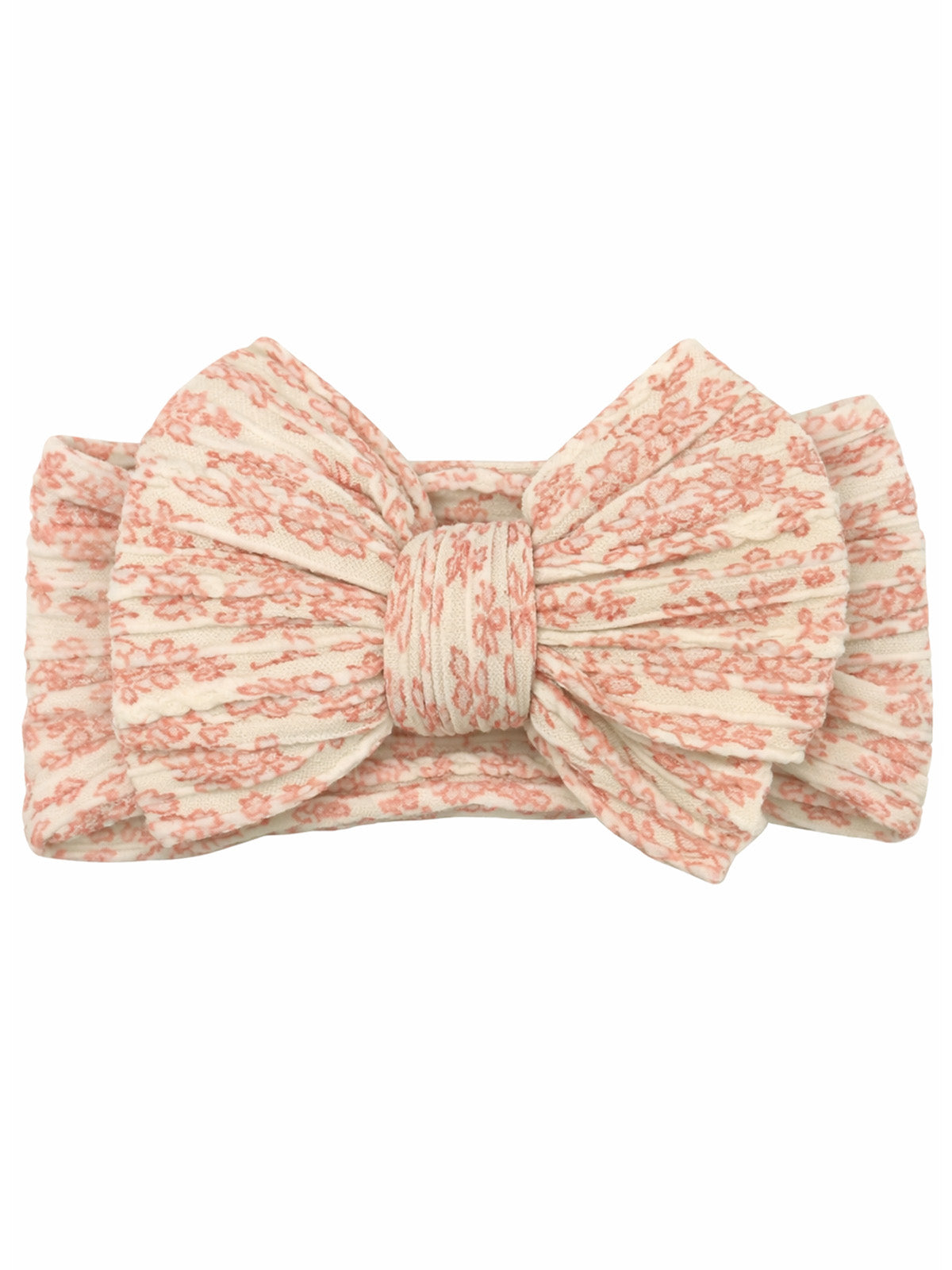 Floral-patterned headband with a large bow in soft peach and cream colors. Ideal for stylish accessories.
