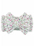 Floral-patterned hair bow in soft white fabric with pink and green accents. Perfect for adding a cute touch to hairstyles.