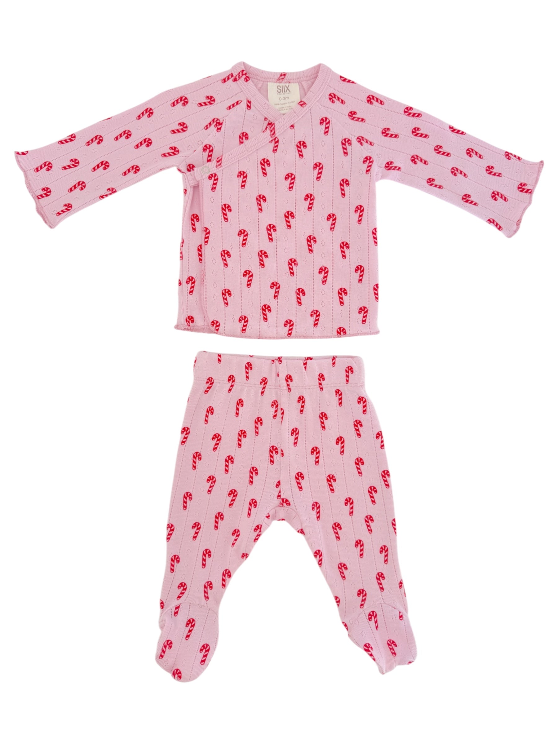 Pink pajama set with candy cane pattern; includes long-sleeved top and matching footed pants.