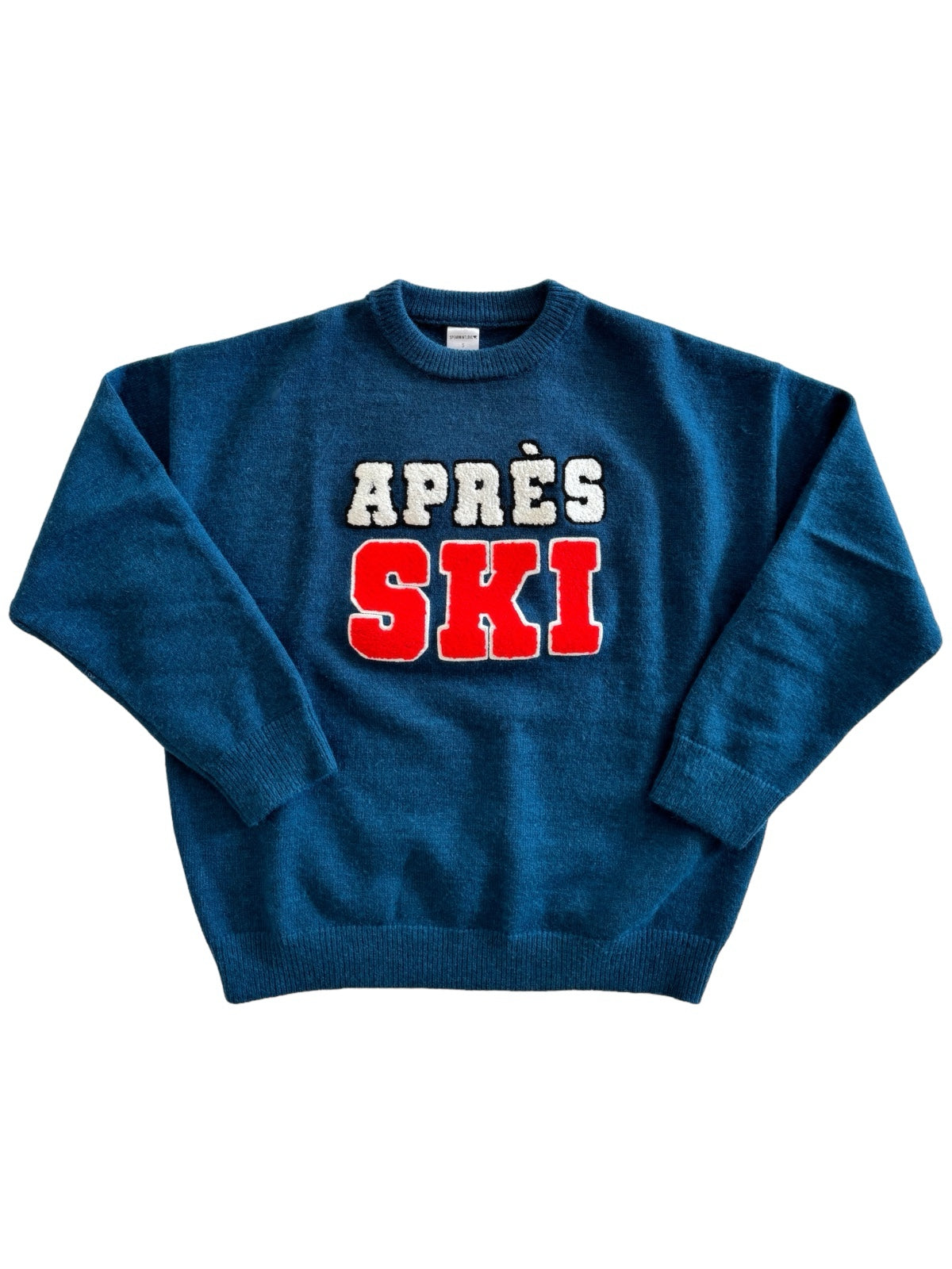 Blue sweater featuring "APRÈS SKI" in white and red lettering. Perfect for winter activities or casual wear.