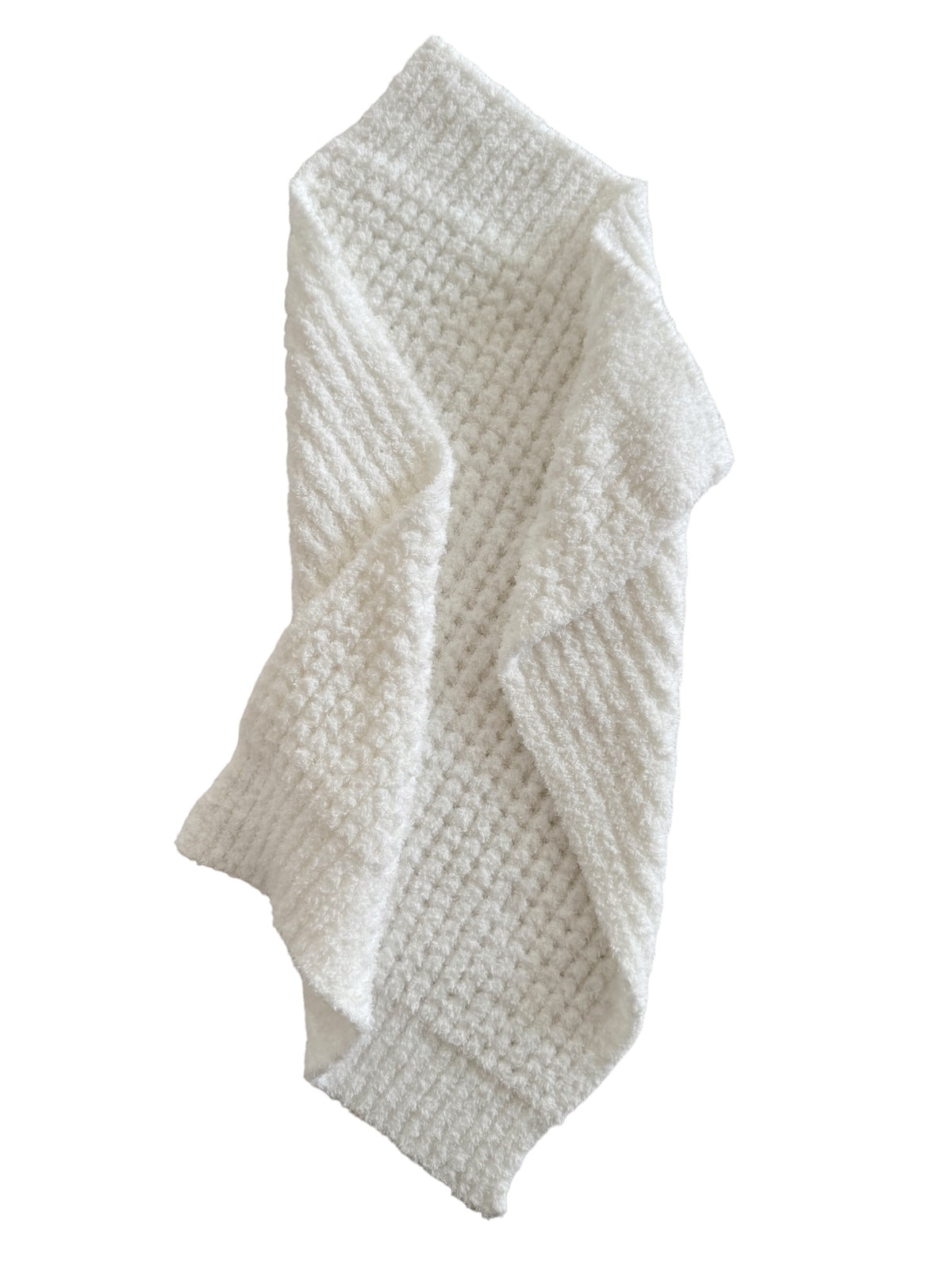 Textured white towel draped elegantly, showcasing a cozy and soft appearance for bathroom or kitchen use.