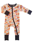 Child's one-piece pajama featuring colorful skull and bow patterns on a light background.