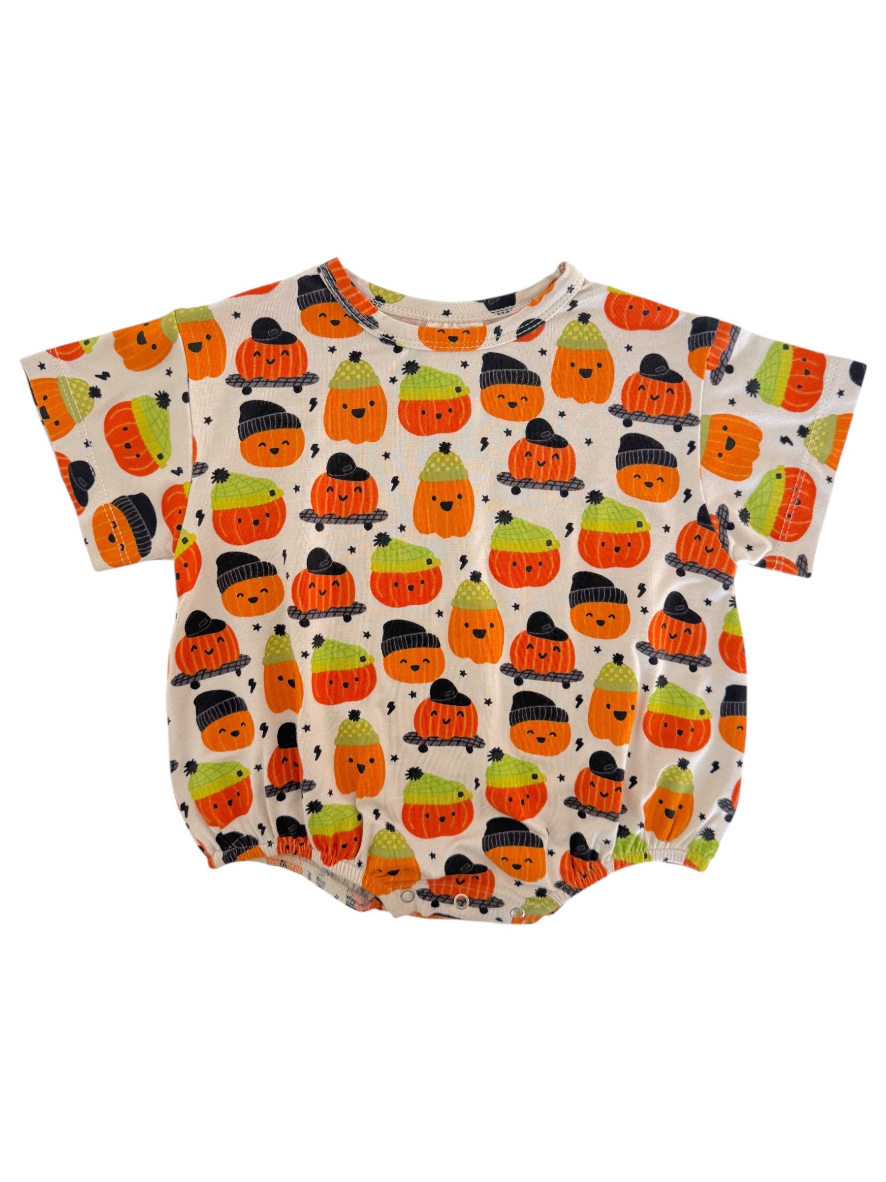 Cute baby shirt with colorful pumpkin designs in orange, green, and black on a light background.