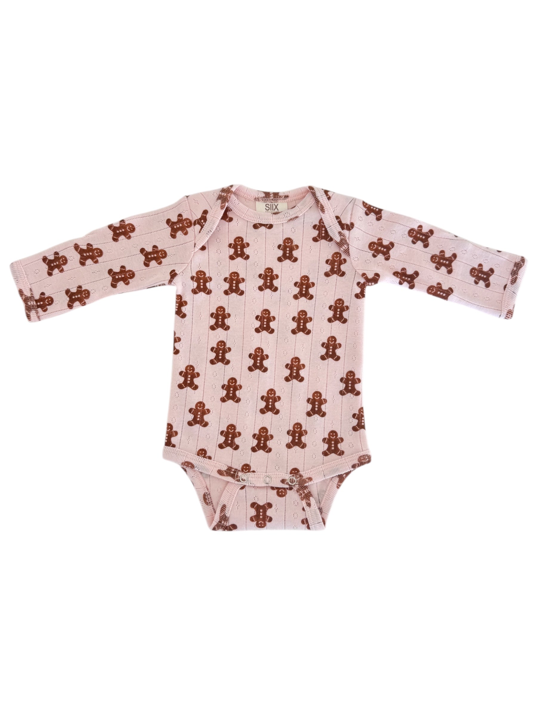 Long-sleeve baby onesie with a pink background and gingerbread man pattern. Perfect for cozy outfits.