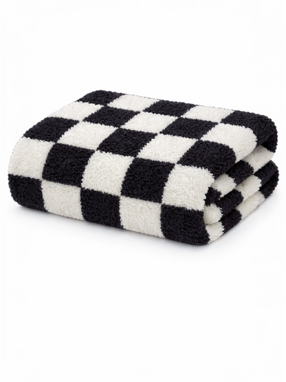 Black and white checkered towel folded neatly on a white background.