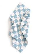 Blue and white checkered towel draped, showcasing its soft texture and pattern.