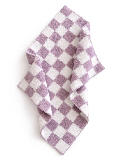Purple and white checkered fabric draped on a flat surface, showcasing its soft texture and pattern.