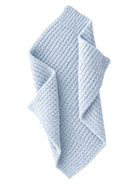 Light blue, textured blanket draped elegantly, showcasing a cozy, woven design.