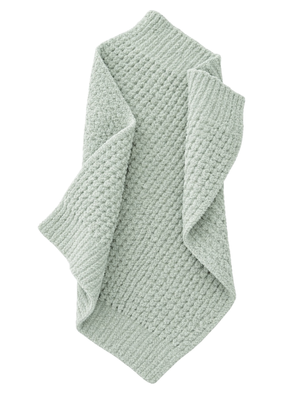 Light green textured blanket draped elegantly, showcasing intricate patterns and cozy fabric.