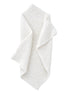 Textured white blanket draped elegantly, showcasing its cozy and soft appearance.