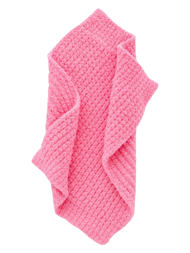 Soft pink textured bath towel folded neatly. Perfect for adding color and comfort to any bathroom decor.