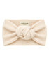Cream-colored knotted headband made of textured fabric, labeled 'SPEARMINTLOVE.'