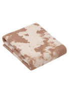 Folded blanket showcasing a beige and brown abstract pattern, suitable for home decor or cozy use.