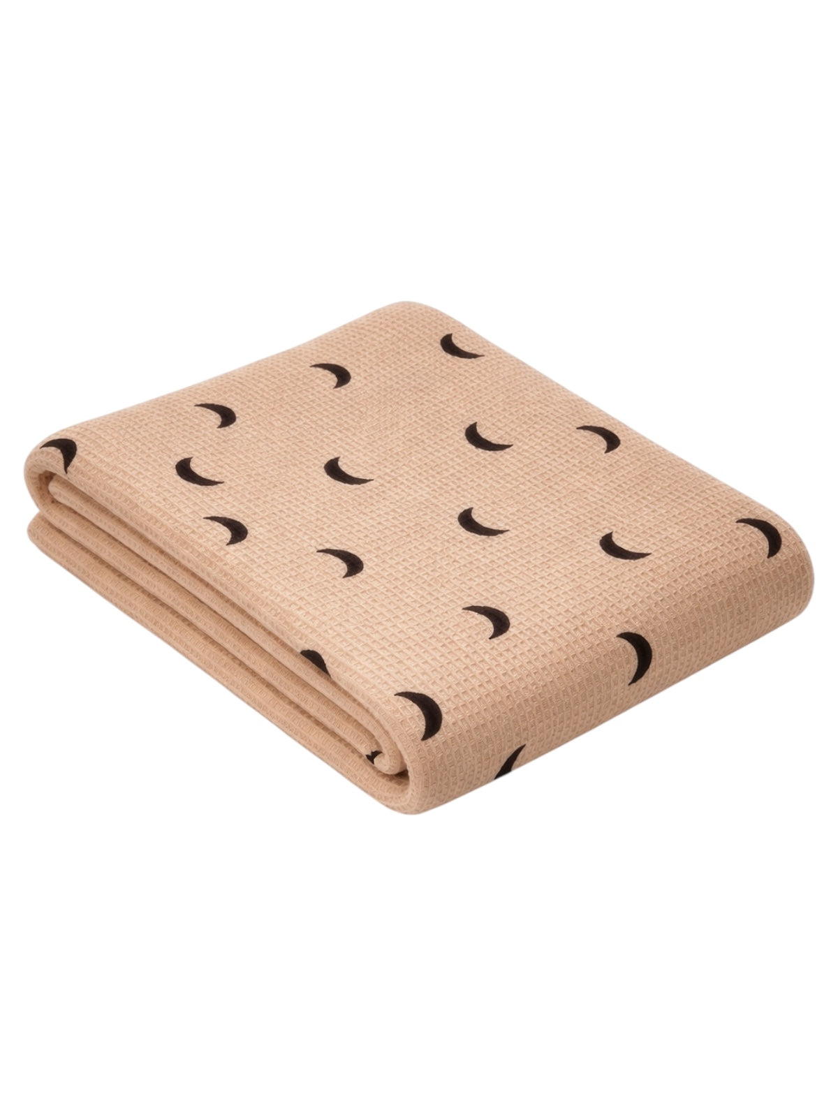 Tan blanket with black crescent moon patterns, folded neatly on a white background.