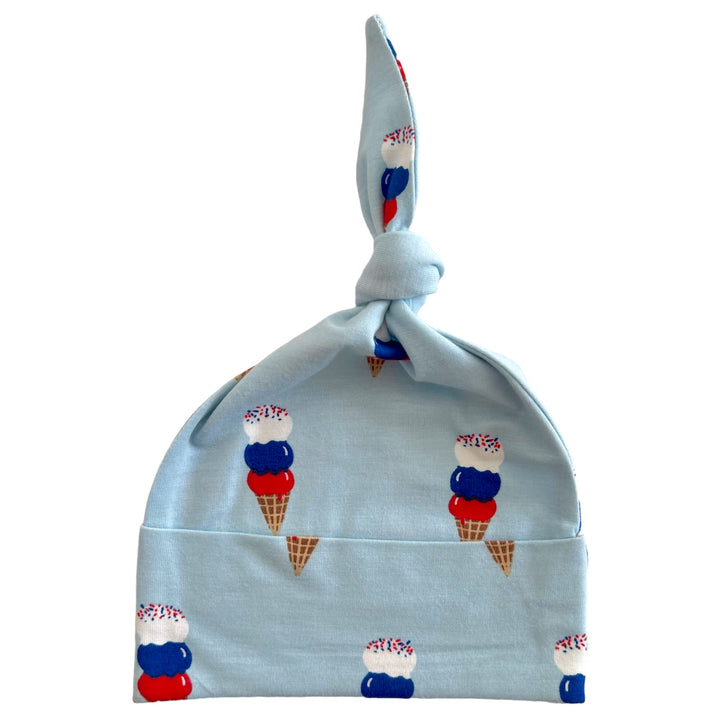 Light blue baby hat with ice cream cone pattern and a knot at the top, ideal for children and summer wear.