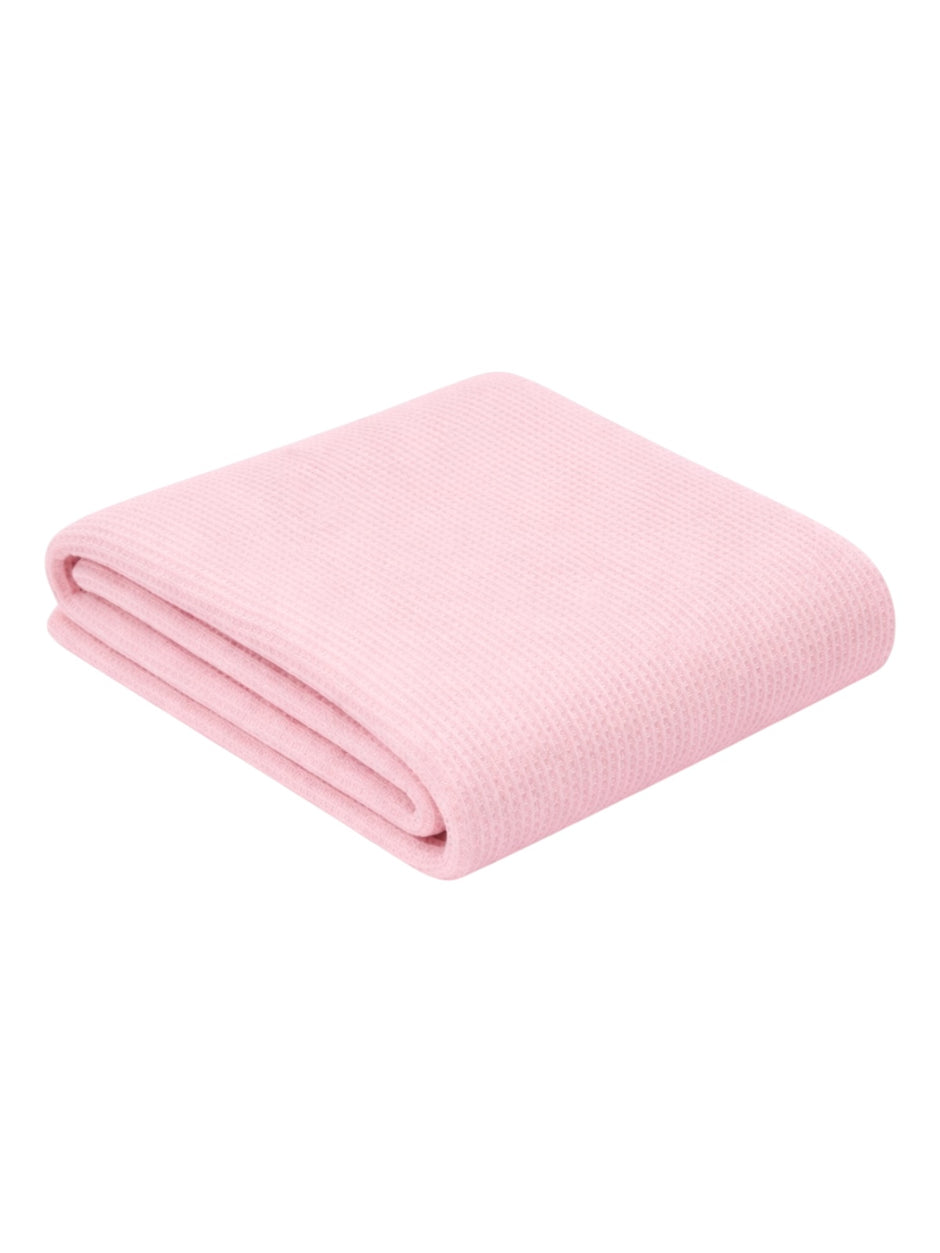 Folded pink blanket with a textured surface, ideal for cozying up or decorative use.