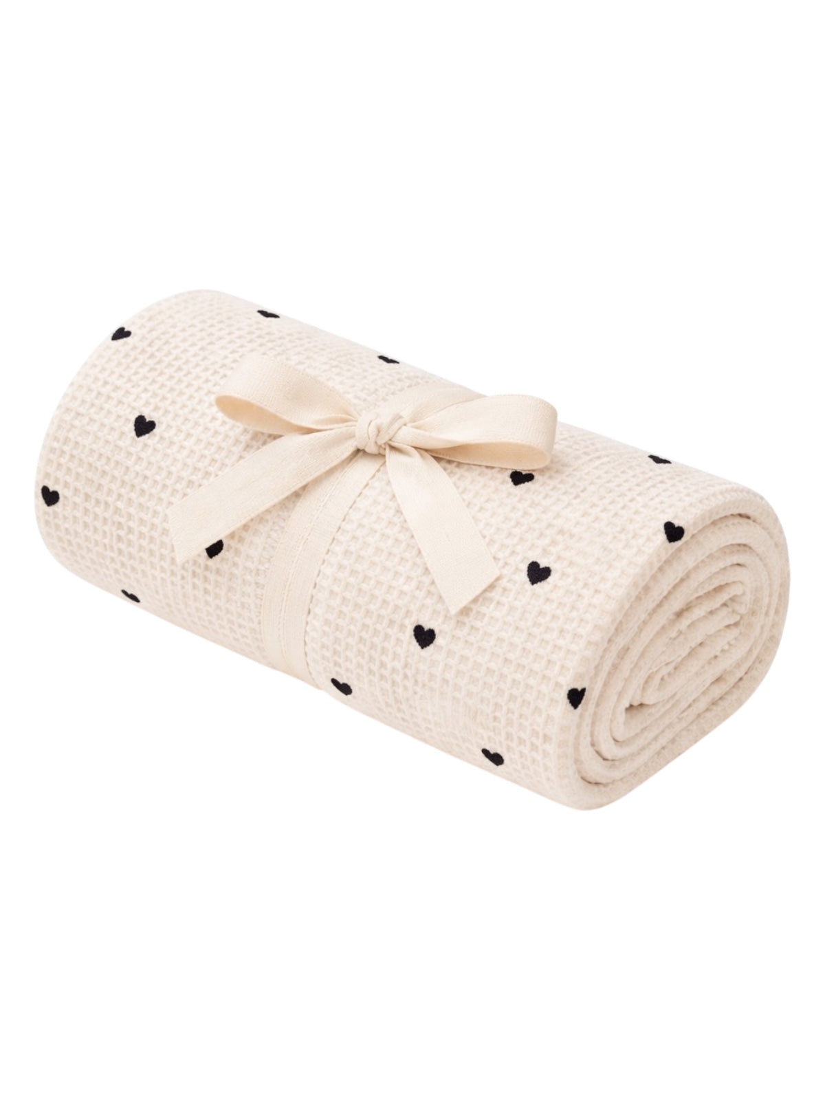 Rolled cream blanket with black heart patterns, tied with a ribbon, ideal for cozy settings and decorative use.