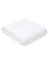 Folded white towel with a textured pattern, placed on a light background.