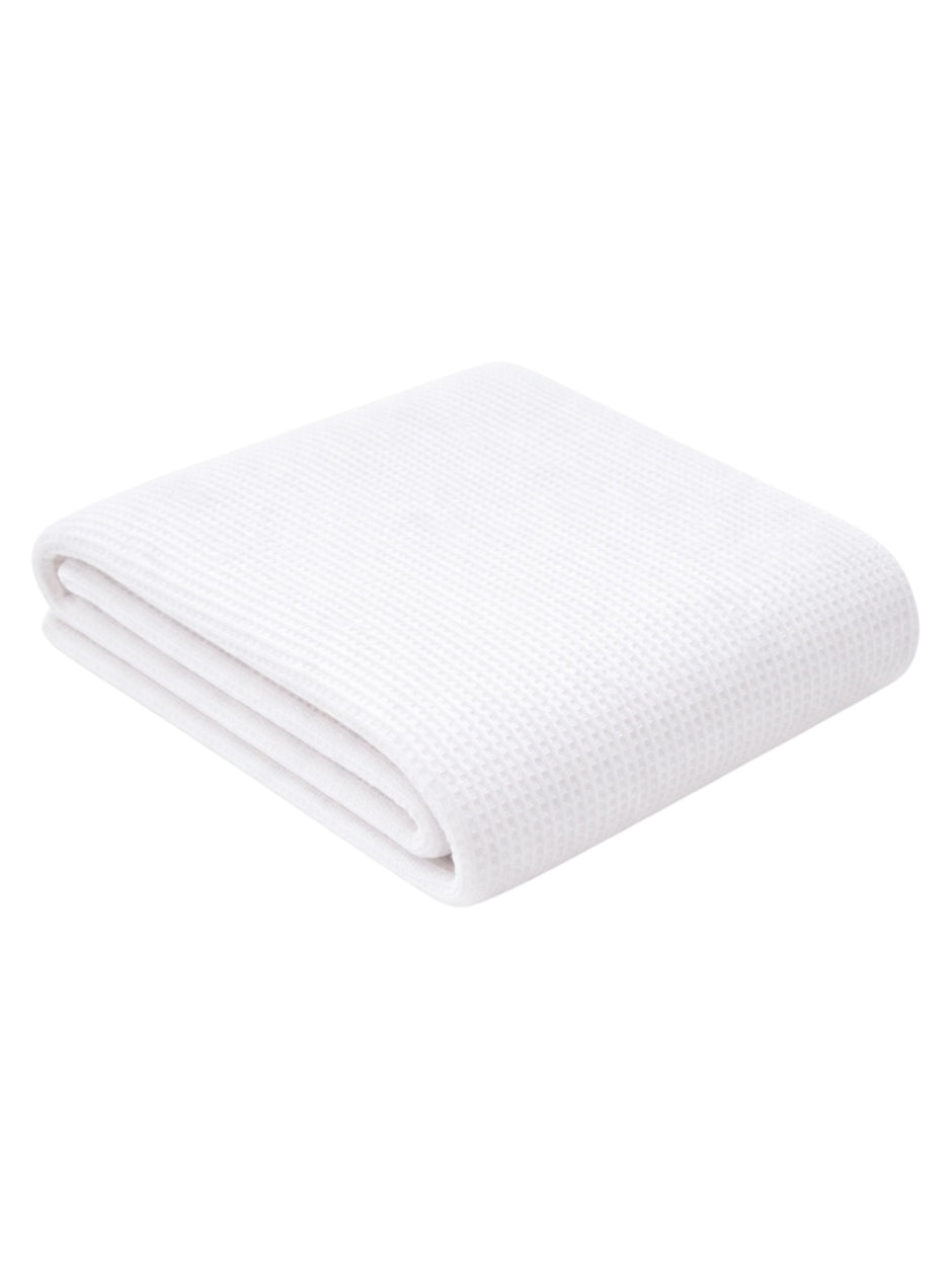 Folded white towel with a textured pattern, placed on a light background.