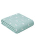 Light green blanket with a textured pattern and white crescent moons, folded neatly on a white background.