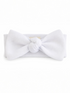 White textured headband with a large bow and knot detail at the center.