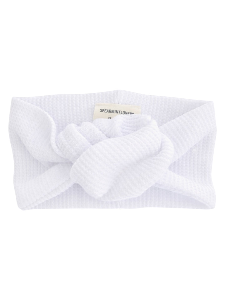 White textured headband with a knotted design in the center, labeled "SPEARMINTLOVE."