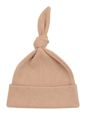 Light brown ribbed baby beanie with a knotted top, perfect for keeping little heads warm.