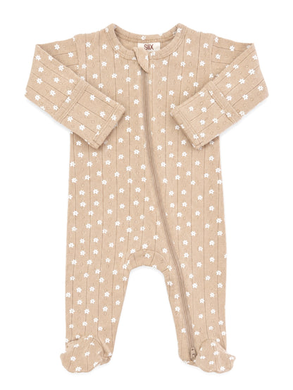 Tan baby onesie with white floral pattern and zip closure. Soft, cozy fabric for infants.