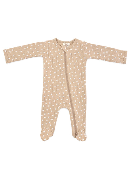 Tan baby onesie with white floral pattern, featuring long sleeves and a front zipper closure.
