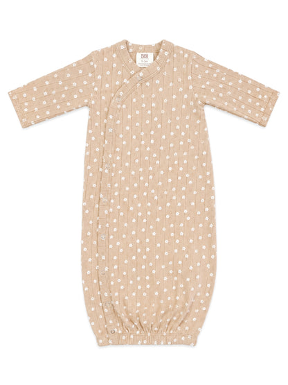 Tan infant sleeping bag with white floral pattern and side snap closure. Ideal for 0-3 months.