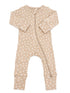 Baby onesie in light beige with white floral patterns and a front zipper. Ideal for comfortable sleepwear.